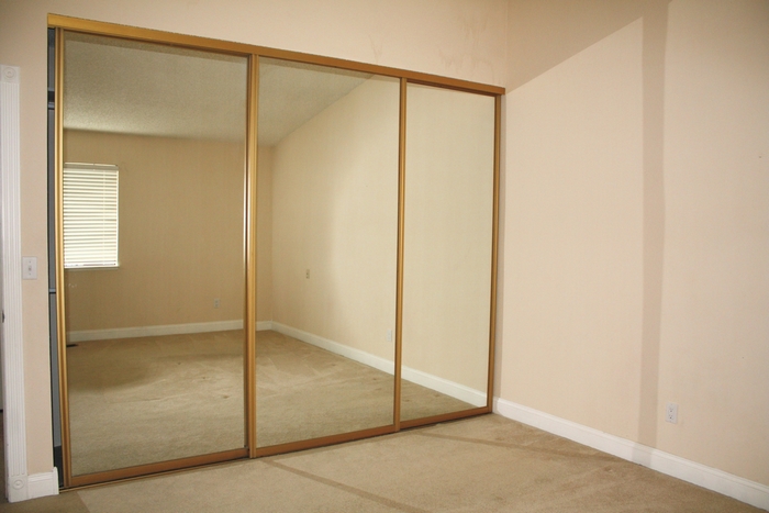 Mirrored closet doors in an empty room