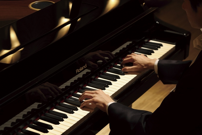 Roland piano with person playing