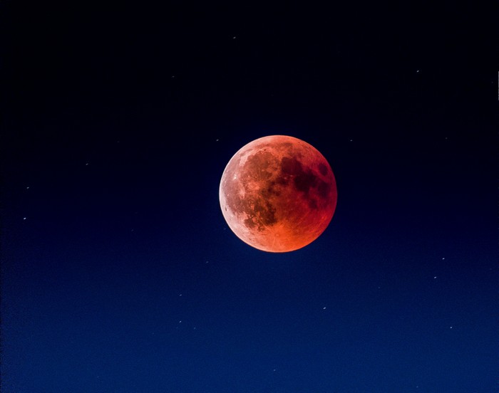 Red moon in a dark starry sky
