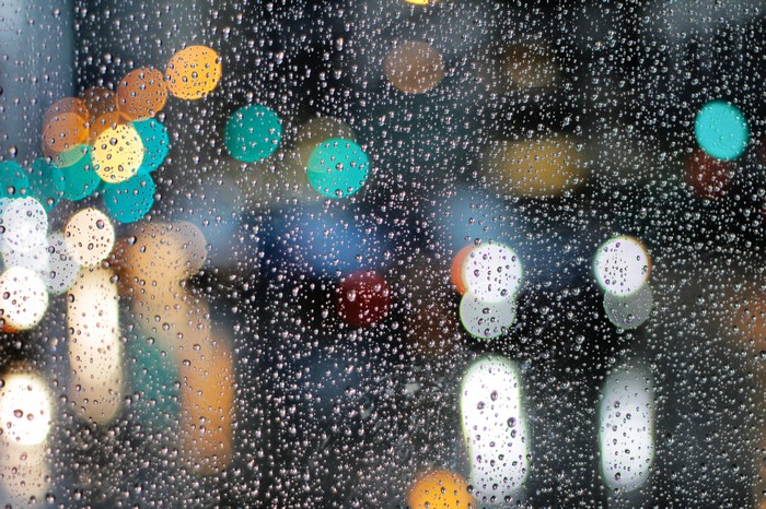 Raindrops on glass with bokeh lights
