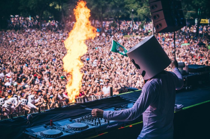 Marshmello DJ performing with fire at a festival