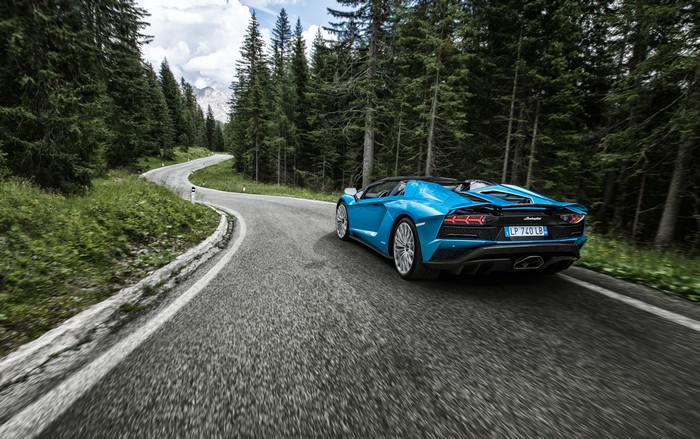 Blue Lamborghini Aventador S driving on a mountain road