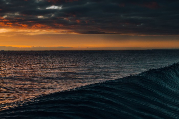 Dark clouds over the ocean at sunset