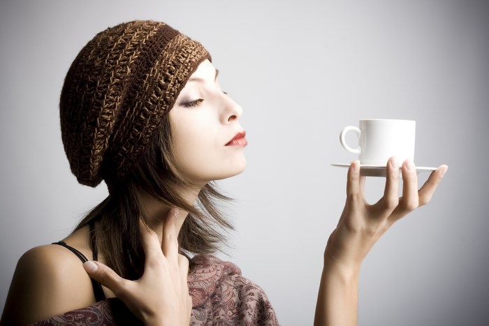 Woman in Knit Hat Savoring Coffee Aroma