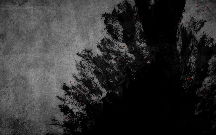 Abstract black ink splatters with red accents on textured gray background