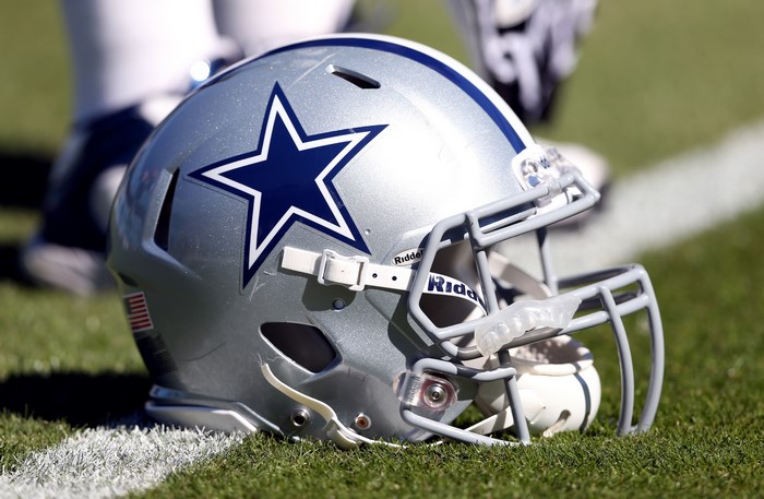 Dallas Cowboys Football Helmet on Grass Field