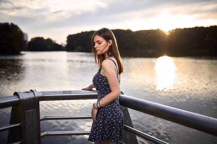 Girl in a floral dress by the water