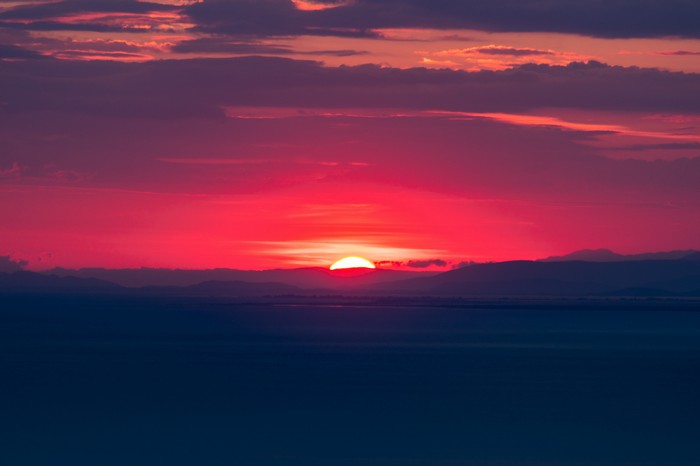 Vibrant sunset over mountains and water