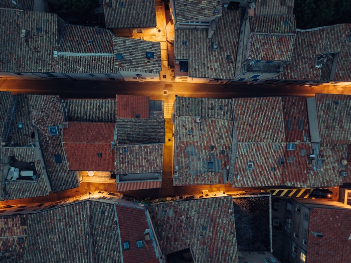 4K Aerial View of Rooftops and Streets at Dusk