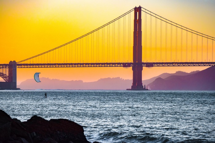 Golden Gate Bridge at sunset with kitesurfer