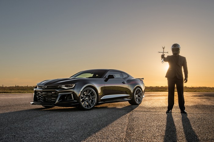 Chevrolet Camaro with a person in a suit and helmet