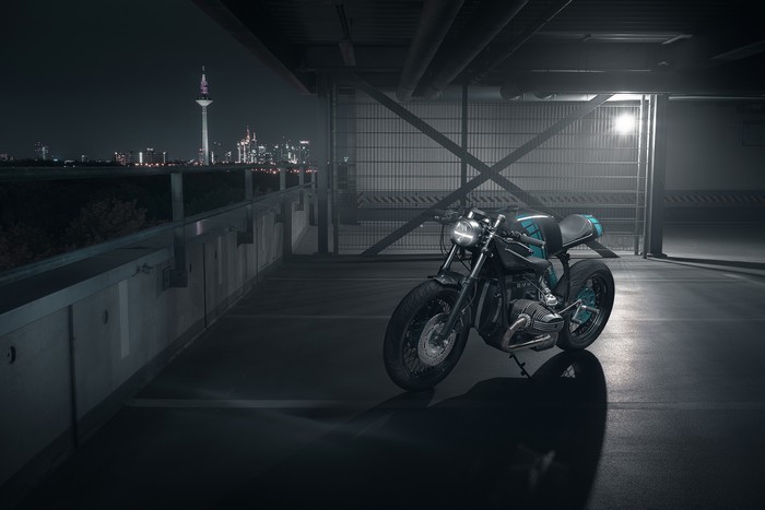 BMW motorcycle parked at night with city skyline
