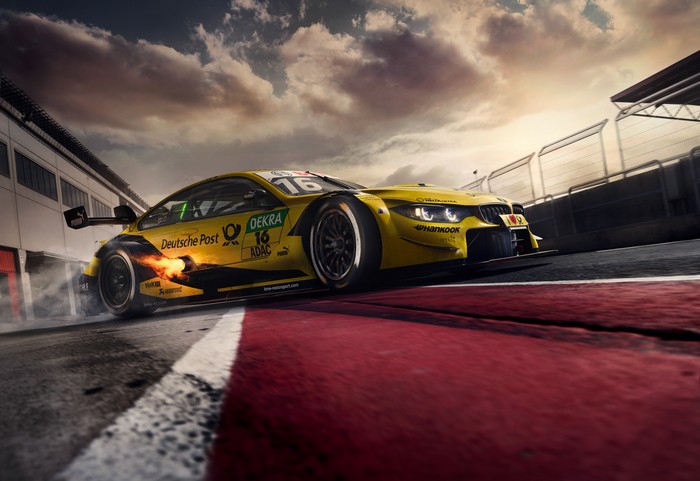 Yellow BMW M4 DTM race car with flames