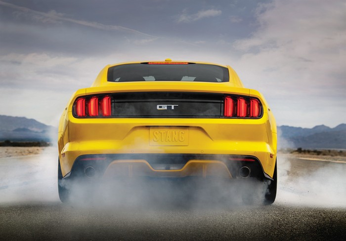 Yellow Ford Mustang GT doing a burnout