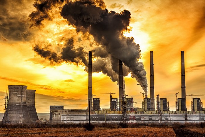 Factory with smoke stacks and cooling towers