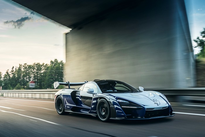 McLaren Senna driving on a highway under a bridge