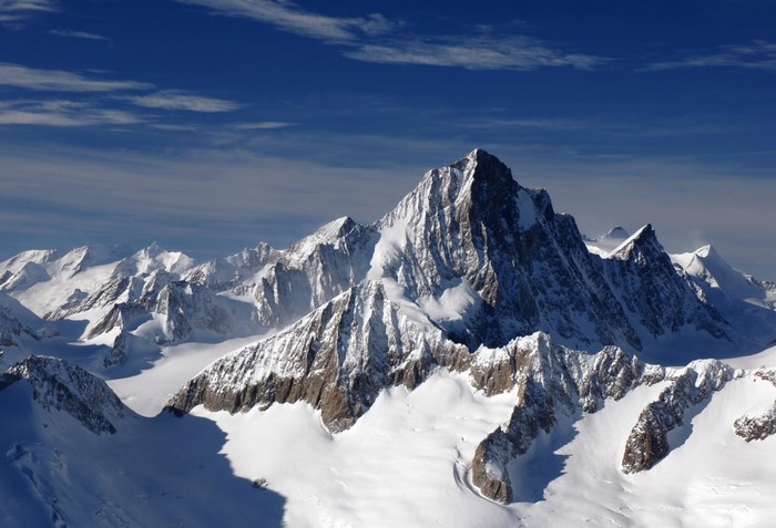 Snowy mountain range under a blue sky