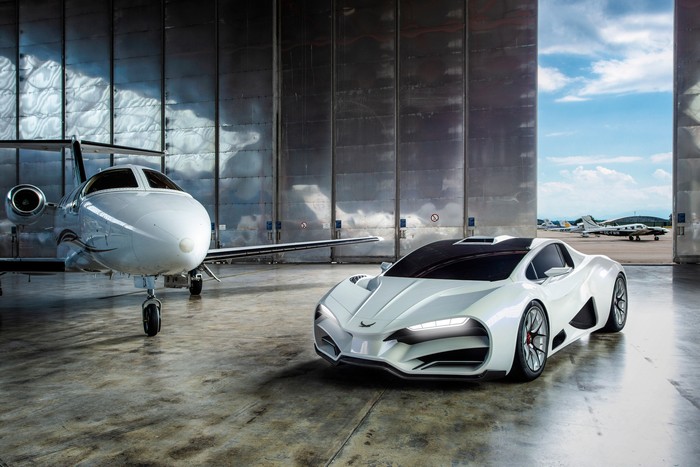 White sports car and private jet in hangar