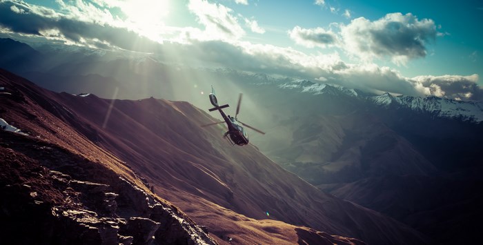 Helicopter flying over mountains