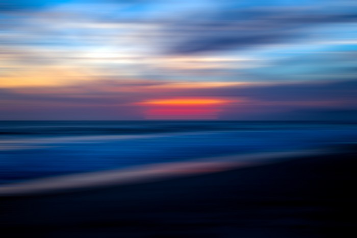 Blurry sunset over the ocean with colorful sky