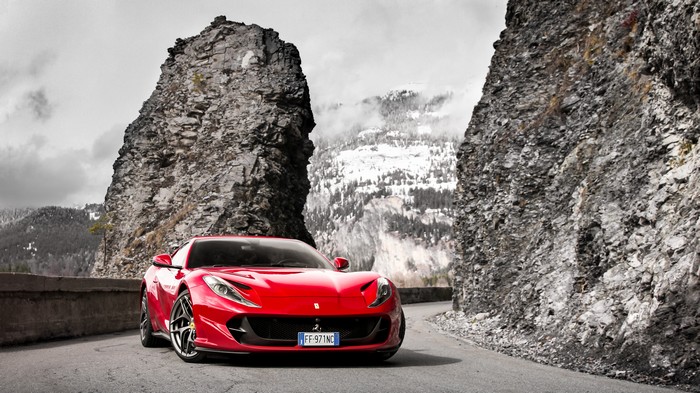 Red Ferrari 812 Superfast on a mountain road