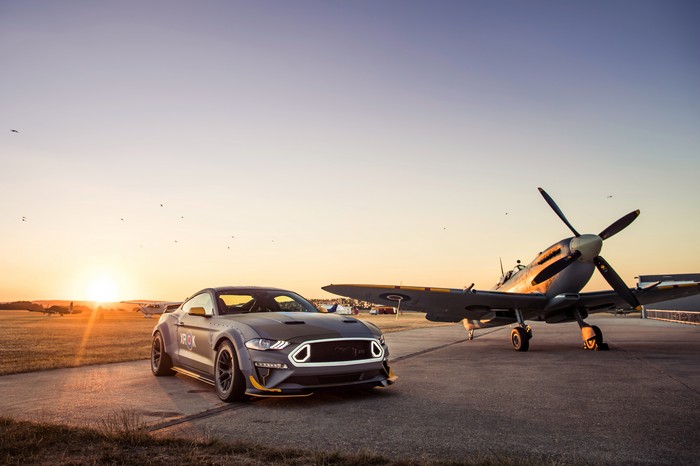 Ford Mustang and Spitfire airplane at sunset