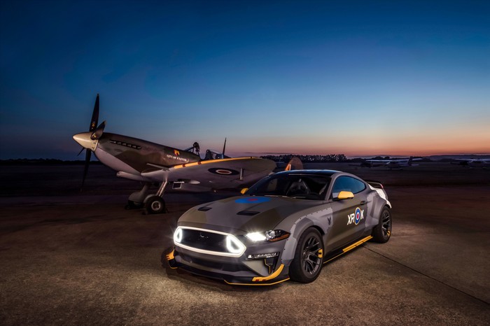 Ford Mustang and Spitfire airplane at dusk