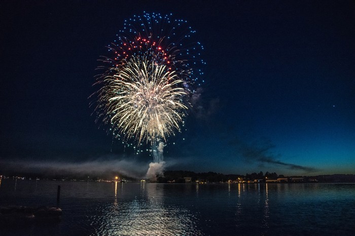 Fireworks over a lake at night
