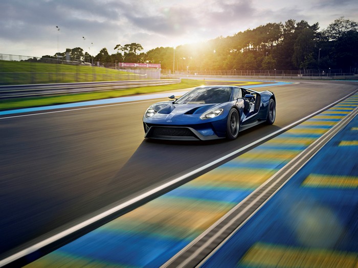 Blue Ford GT racing on a track