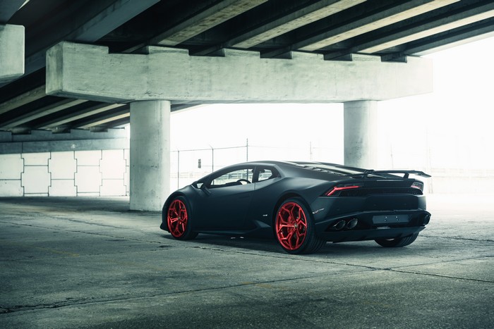 Matte black Lamborghini Huracan with red wheels