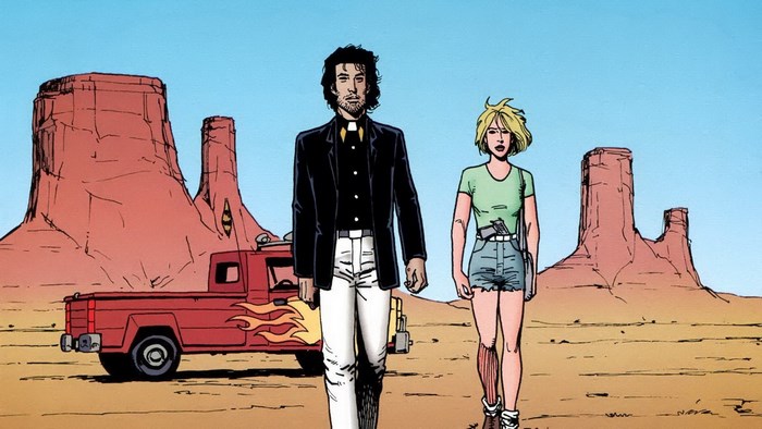 Preacher and woman in desert with truck