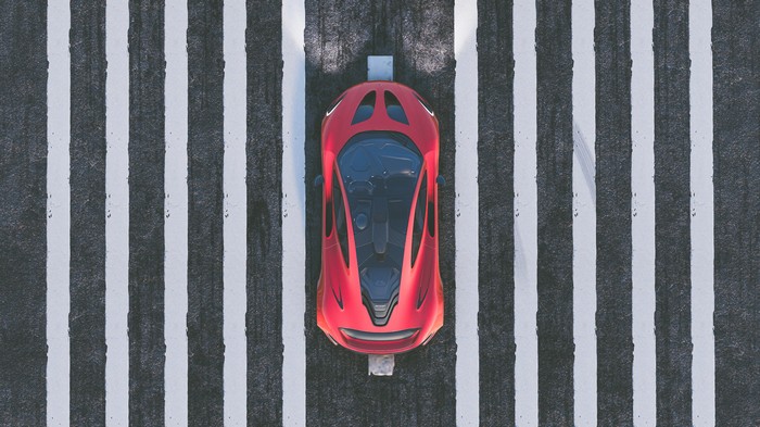 Red McLaren P1 on a striped road