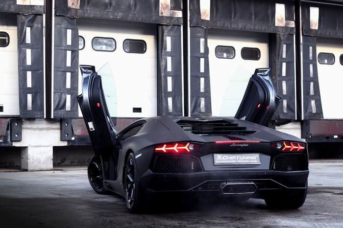 Matte black Lamborghini Aventador with doors open