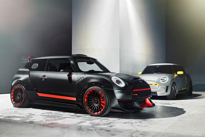 Two Mini Cooper cars in a studio setting