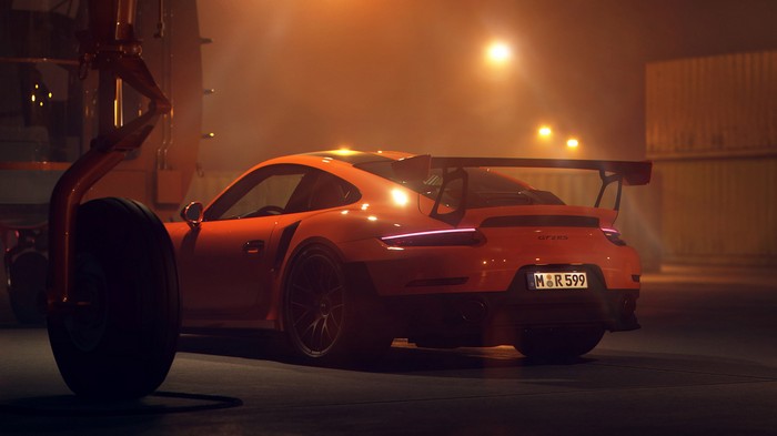 Orange Porsche 911 GT2 RS with a large rear spoiler