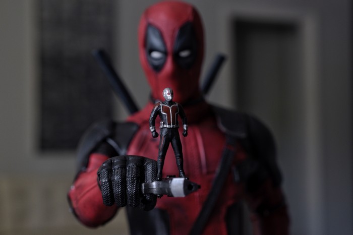 Deadpool holding Ant-Man figurine