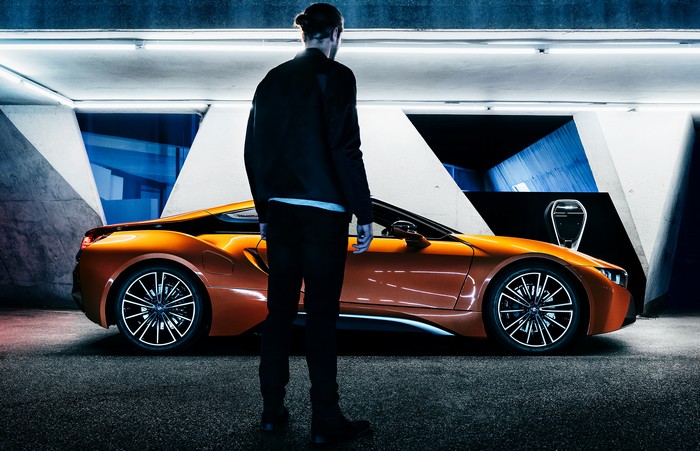 BMW i8 parked with a man standing nearby