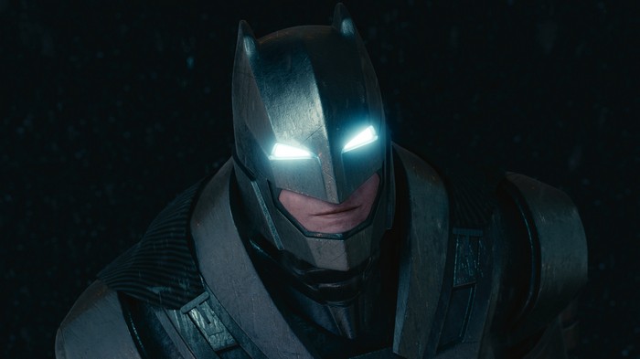 Batman in armored suit with glowing eyes