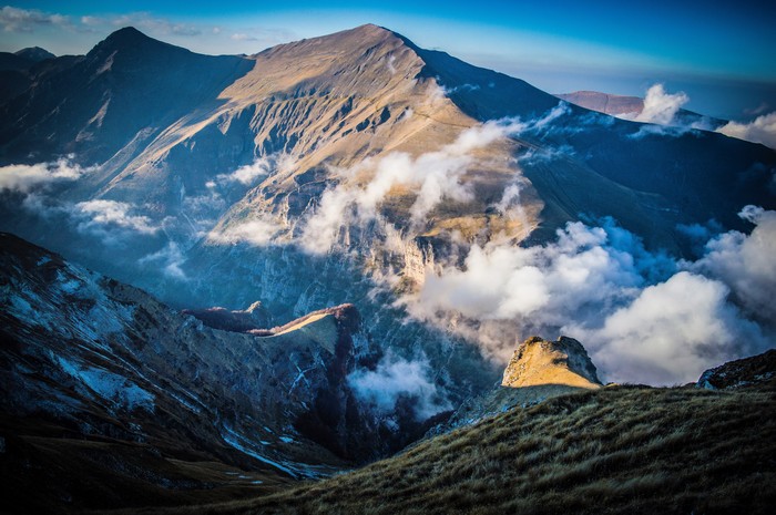 Sunlit Mountain Peaks with Clouds in 4K