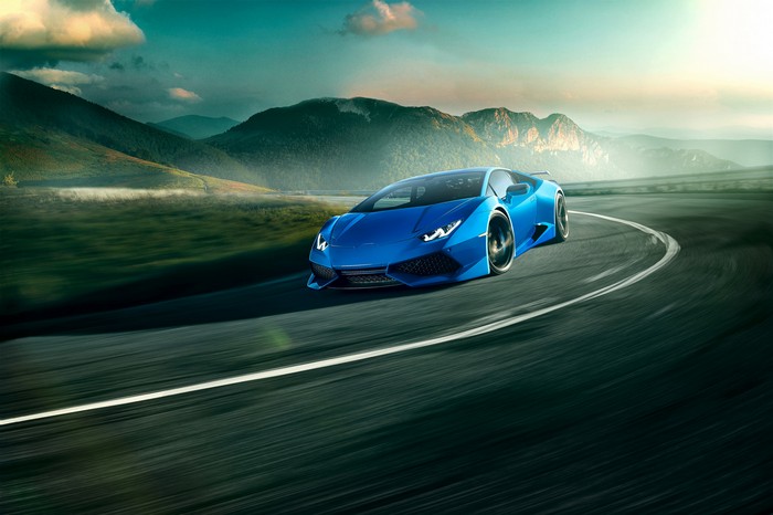Blue Lamborghini Huracan driving on a winding road