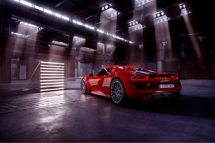 Red Porsche 918 in a studio with lights