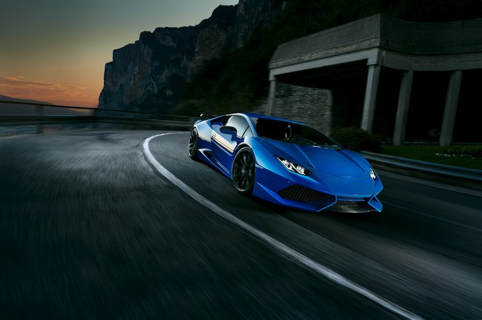 Blue Lamborghini Huracan driving on a mountain road