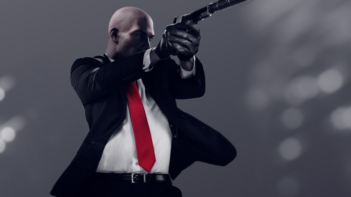 Agent 47 from Hitman aims a pistol