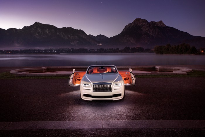 Rolls-Royce Dawn convertible parked by a lake at dusk