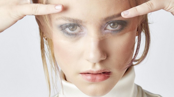 Lili Reinhart with a sheer fabric over her face