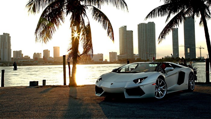White Lamborghini Aventador convertible by the water