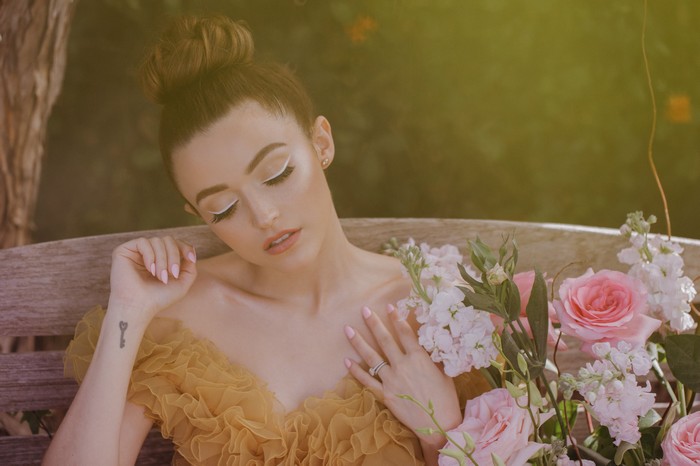 Kathleen Lights Poses with Flowers
