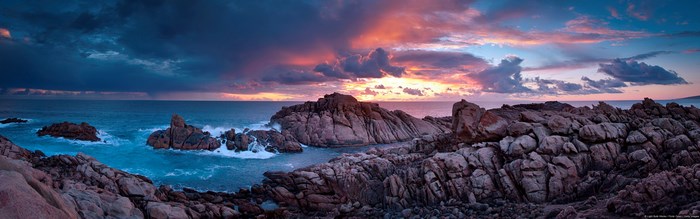 Rocky coastline at sunset with dramatic clouds