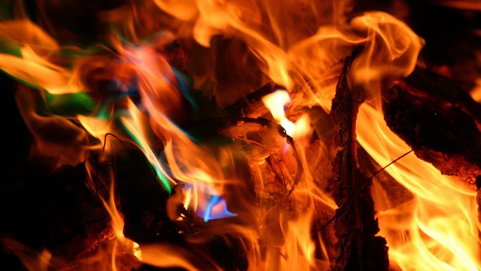 Close-up of colorful flames and burning wood