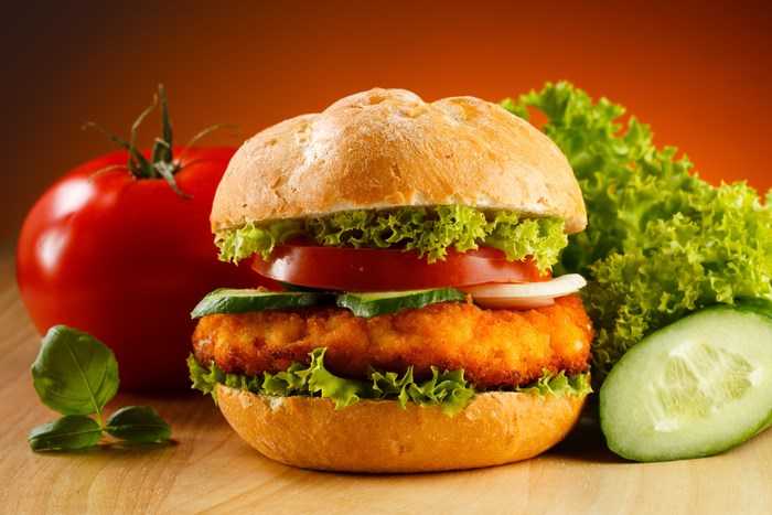 Burger with tomato, lettuce, and cucumber